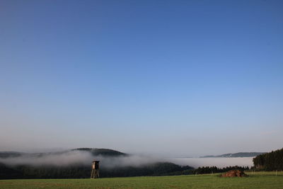 Scenic view of agricultural field against clear sky