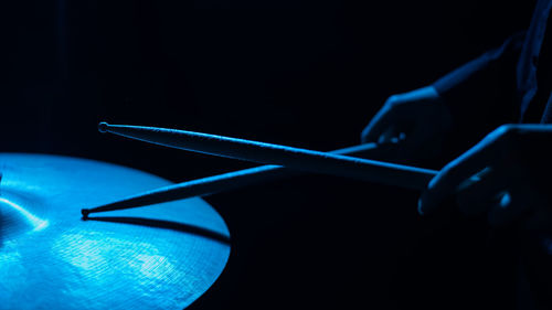 Close-up of hand against blue background