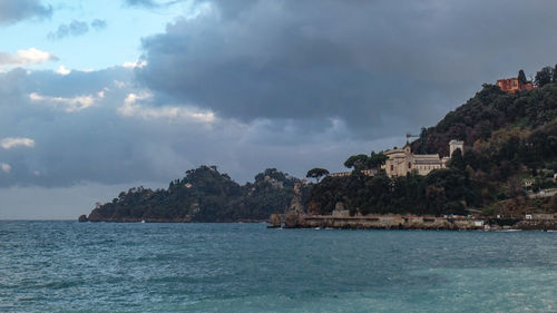 Panoramic view of sea and buildings against sky