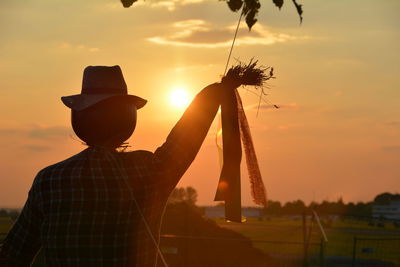 Scarecrow against sky during sunset