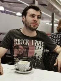 Young man sitting on table