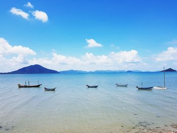 Boats moored on sea against sky