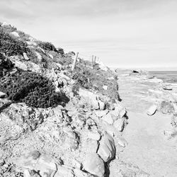 Scenic view of rocks on beach against sky