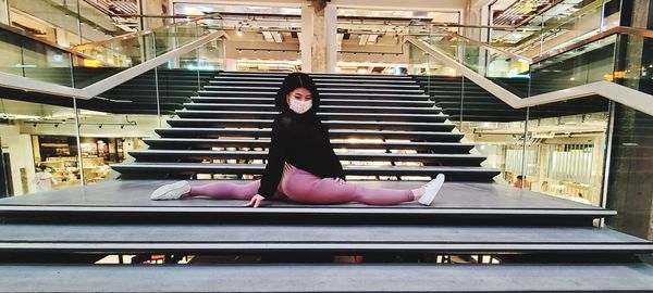 Portrait of woman sitting on staircase