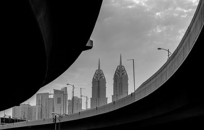 Low angle view of skyscrapers seen through bridge