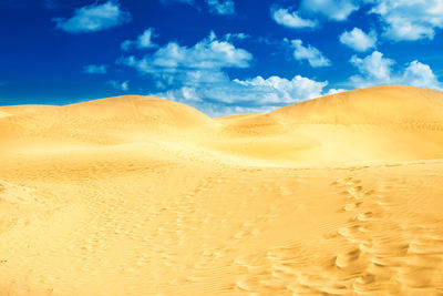 Desert with sand dunes and clouds on blue sky. landscape of maspalomas dunes. gran canaria, spain