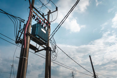 Low angle view of electricity pylon against sky