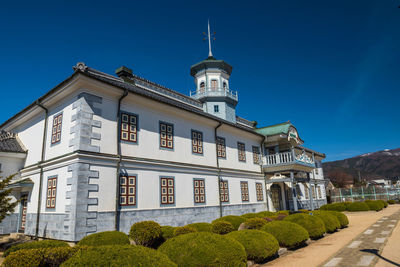 Low angle view of building against blue sky