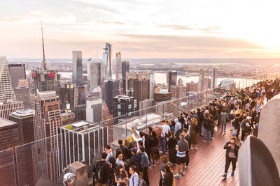 High angle view of crowd in city against sky during sunset