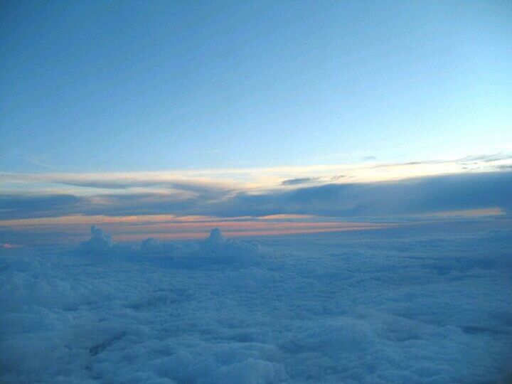 scenics, tranquil scene, tranquility, blue, beauty in nature, sky, landscape, nature, copy space, idyllic, cloud - sky, aerial view, cloud, cloudscape, horizon over land, outdoors, no people, majestic, non-urban scene, remote