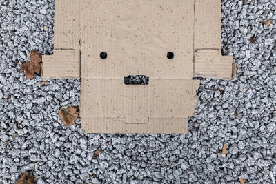 High angle view of cardboard box on stones