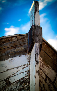 Low angle view of old wooden fence against sky