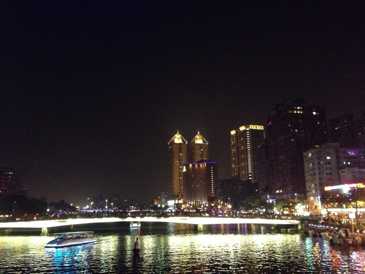 illuminated, building exterior, night, water, city, architecture, waterfront, built structure, cityscape, skyscraper, reflection, river, urban skyline, modern, clear sky, office building, tall - high, copy space, tower, sky