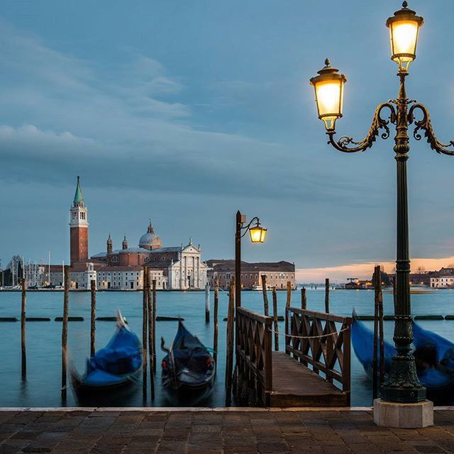 street light, lighting equipment, lamp post, illuminated, water, sky, architecture, built structure, railing, sea, building exterior, electric light, outdoors, lantern, reflection, no people, pier, nature, electric lamp, lamp