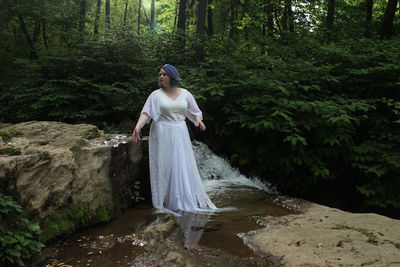 Woman standing in forest