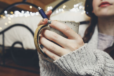 Close-up of woman holding camera