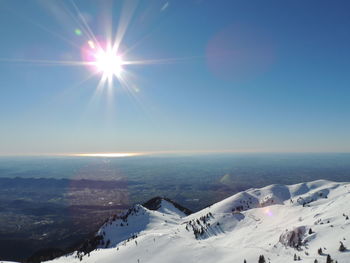 Scenic view of snowcapped mountains against sky