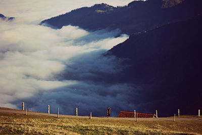 Scenic view of field against cloudy sky