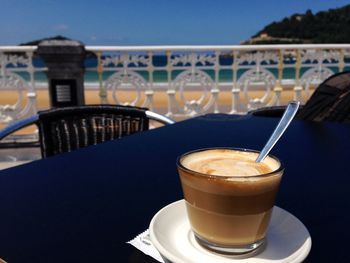 Close-up of coffee served on table against sky