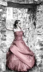 Young woman standing against tree