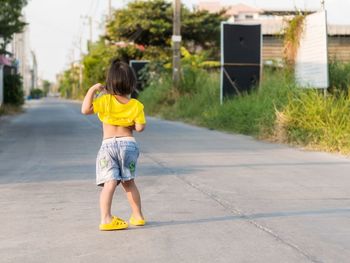 Rear view of woman on road