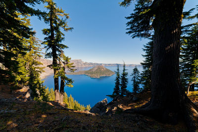 Scenic view of lake and mountains against clear sky