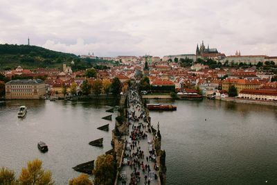 Scenic view of river by city against sky