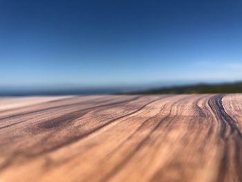 Surface level of land against clear blue sky