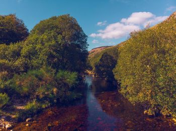 Scenic view of waterfall against sky during autumn