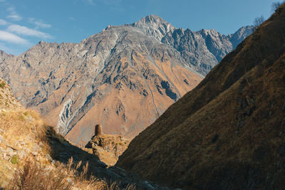 Landscape view of gergeti tower ruins on mount kazbek trail in stepansminda, kazbegi, georgia.