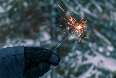 Burning sparklers in a hand outdoors
