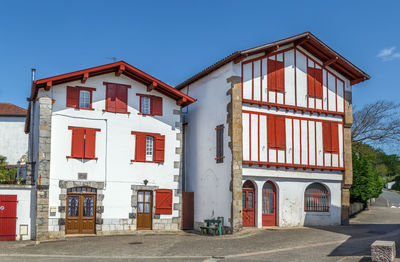 Exterior of house by building against sky