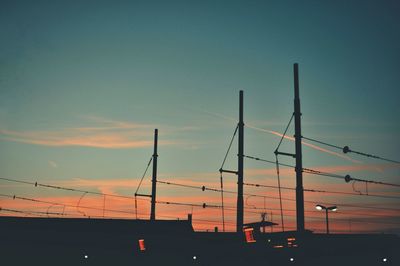 Low angle view of silhouette bridge against sky at sunset