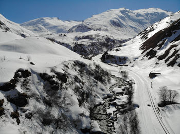 Scenic view of snow covered mountains against sky