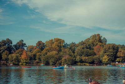 Scenic view of lake by trees against sky