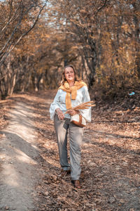 Portrait of teenage girl holding autumn leaf