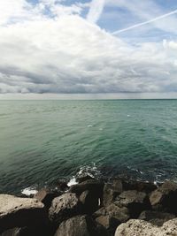 Scenic view of sea against cloudy sky