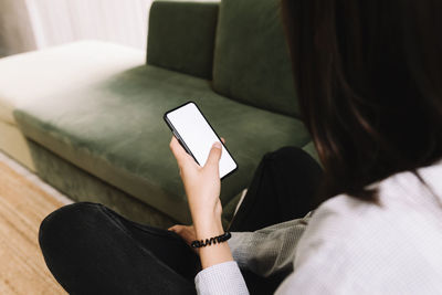 Midsection of man using mobile phone