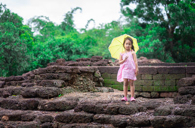 Full length of a woman standing in rain