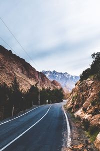 Road amidst mountains against sky