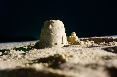 Close-up of sand on beach against sky