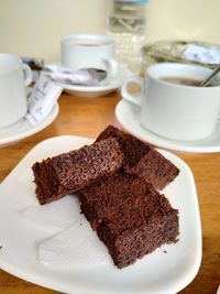 Close-up of cake with coffee served on table