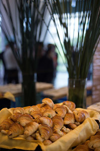 Fresh croissants in basket at restaurant