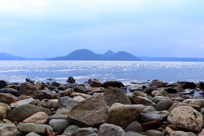 Rocks on beach against sky