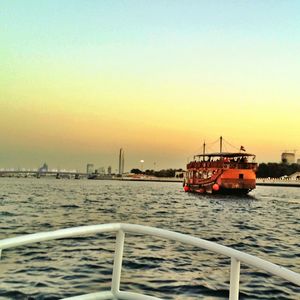 Boat in sea at sunset