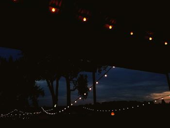 Low angle view of illuminated bridge against sky at night