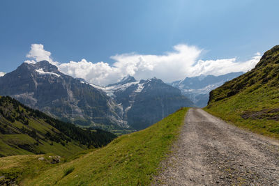 Road amidst mountains against sky