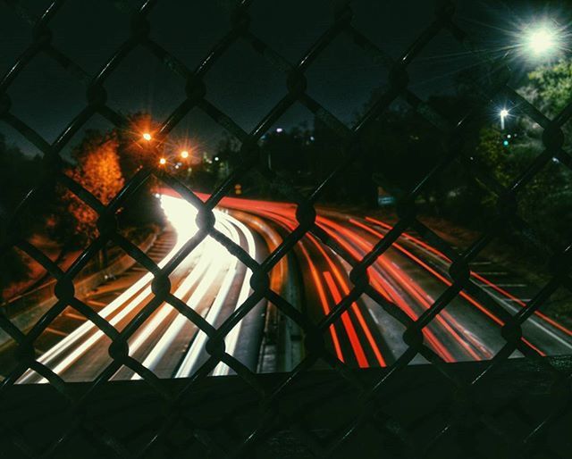 illuminated, protection, pattern, chainlink fence, night, safety, fence, metal, lighting equipment, no people, multi colored, design, red, security, outdoors, sky, window, glass - material, close-up