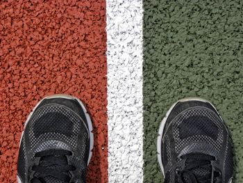 Low section of person standing on sports track