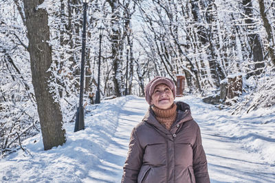 Portrait of smiling woman in snow